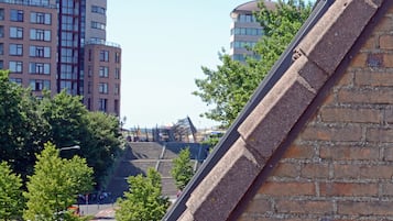 A view of a modern building with a brick facade and a staircase leading to an upper level.