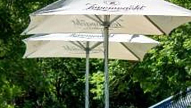A person lying on a lounge chair under a canopy umbrella. - Swartberg Country Manor (Oudtshoorn)