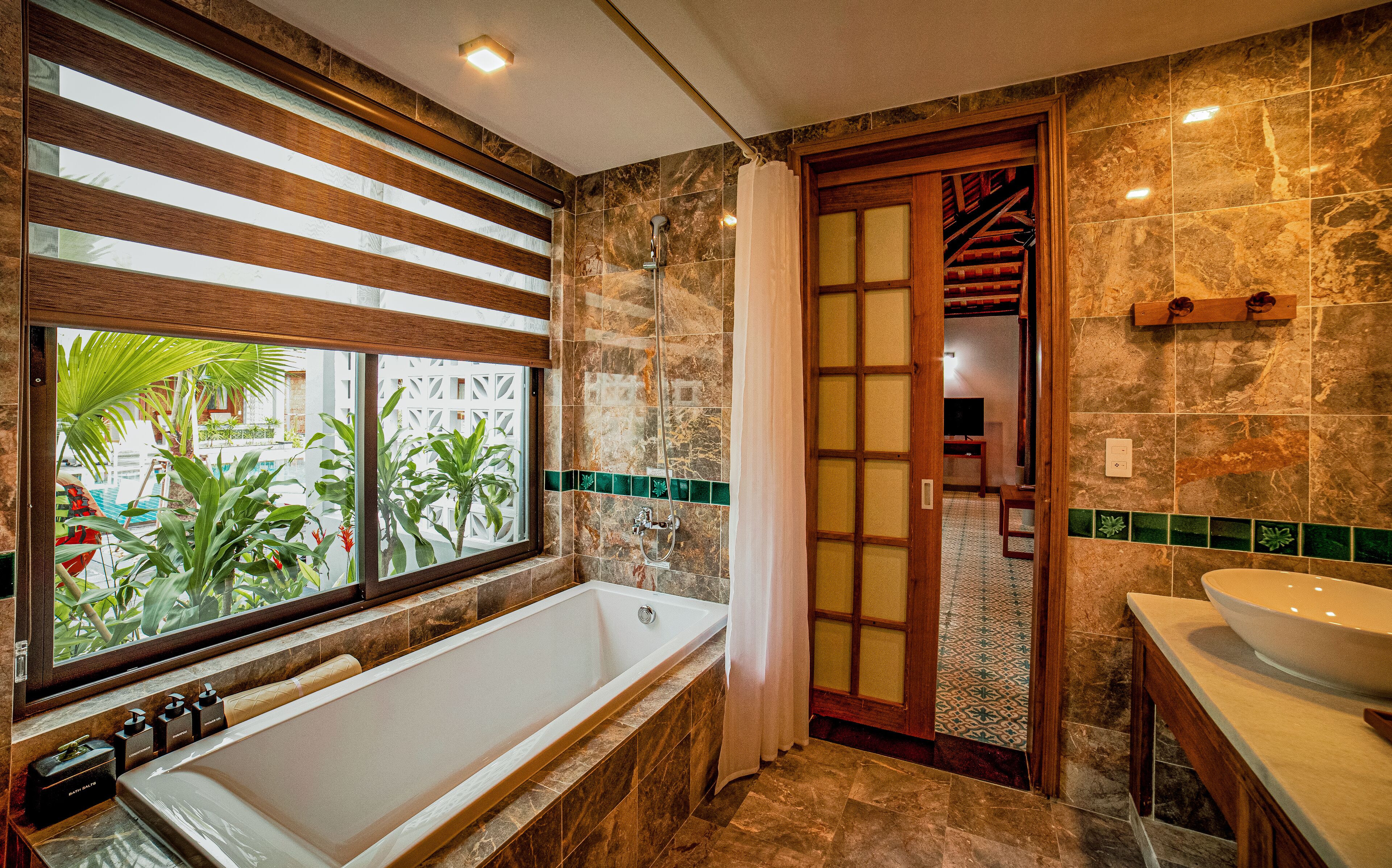 combined shower/bathtub, rainfall showerhead, designer toiletries