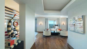 Experience the sleek lobby with a long floor, contemporary seating area, and unique artwork.