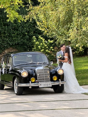 A vintage black car parked on a paved surface with a license plate visible. - Pazo do Río (Oleiros)