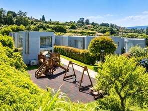 A residential area with modern mobile homes, a playground, and well-maintained gardens. - Pazo do Río (Oleiros)