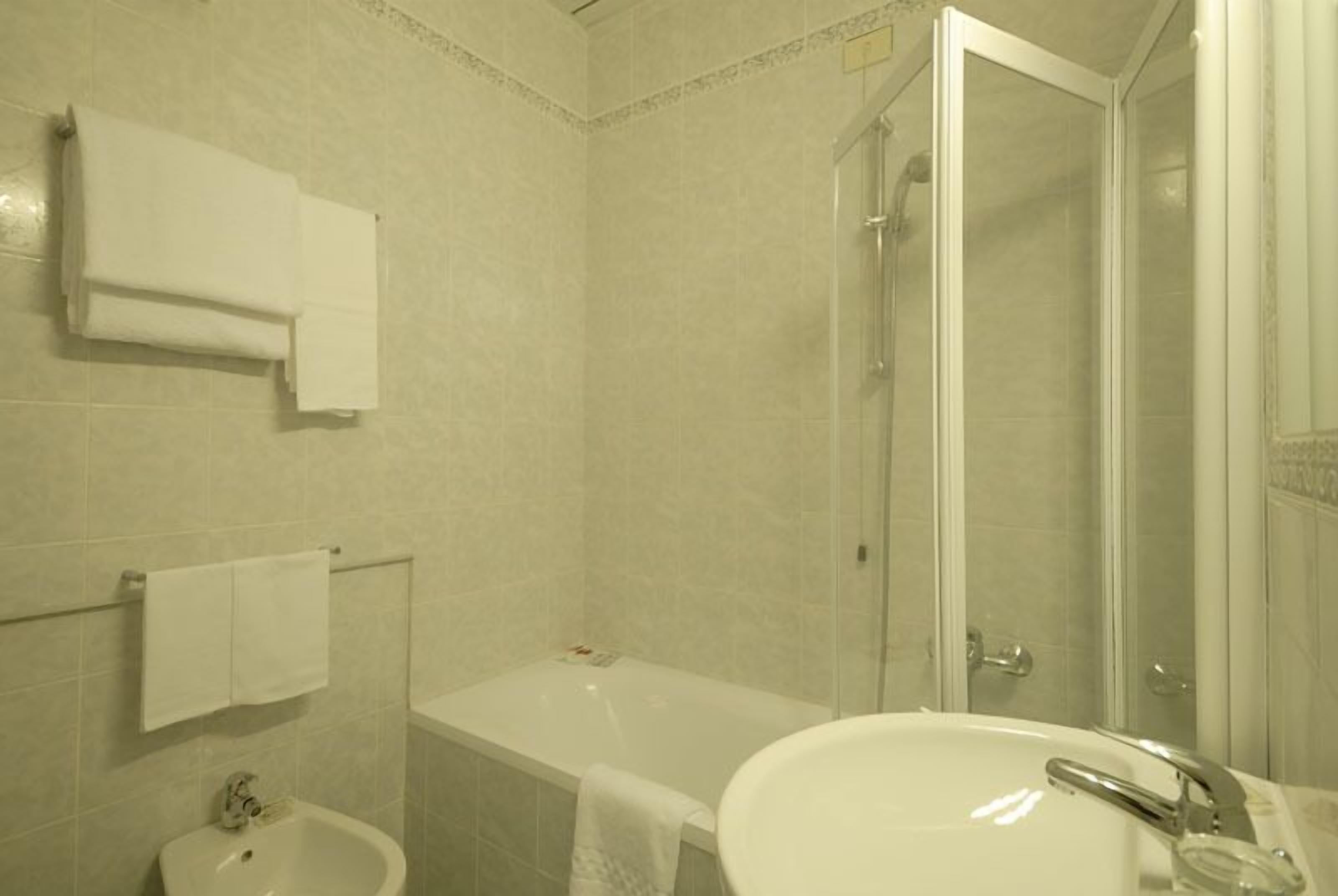 A bathroom with a bathtub, a sink, and a shower.