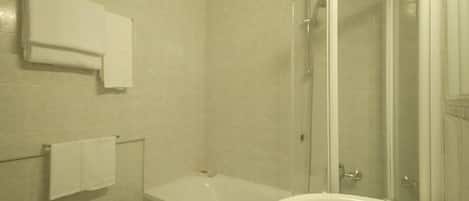 A bathroom with a bathtub, a sink, and a shower.