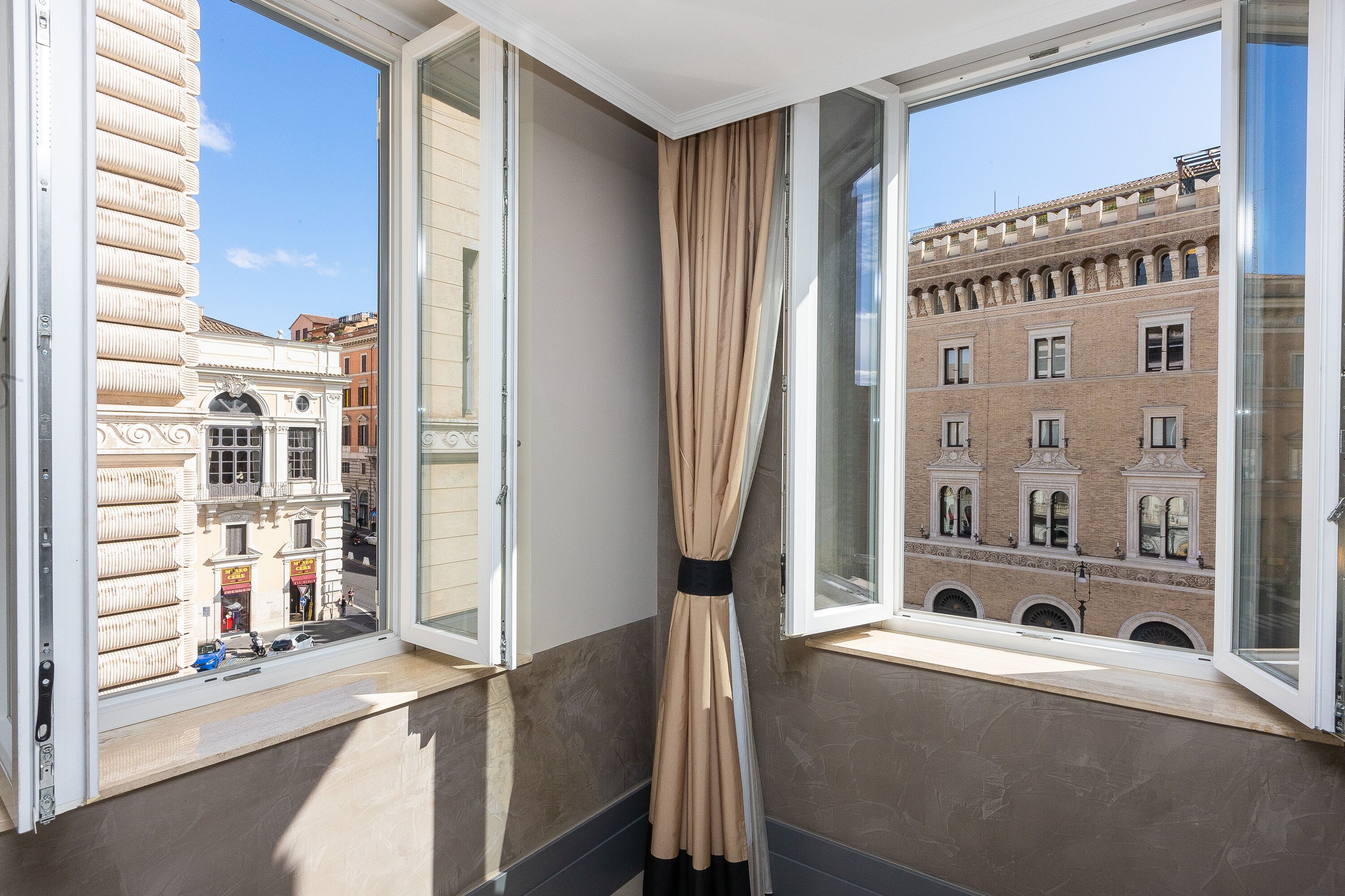 A corner room with a view of a historic building.