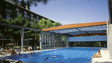 Relax by the pool surrounded by a glass enclosure offering unobstructed views.