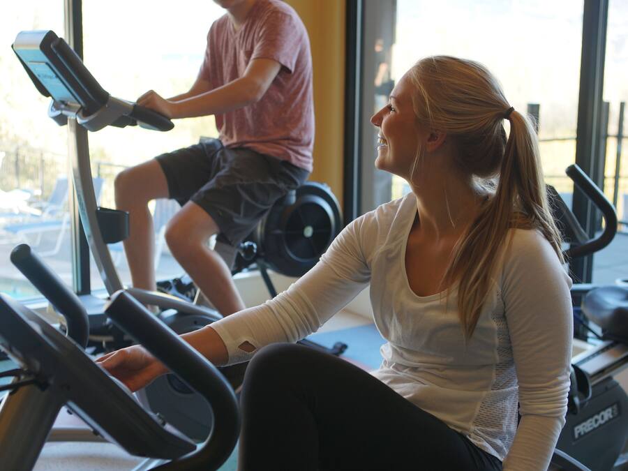 A gym with stationary bikes and a treadmill.