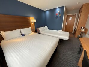 A hotel room with two beds, a nightstand, a lamp, and a door. - Holiday Inn Express Nuneaton by IHG (Nuneaton)