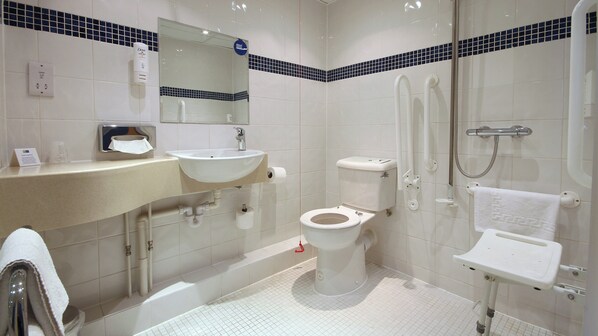 A modern bathroom with a sink, toilet, and shower.