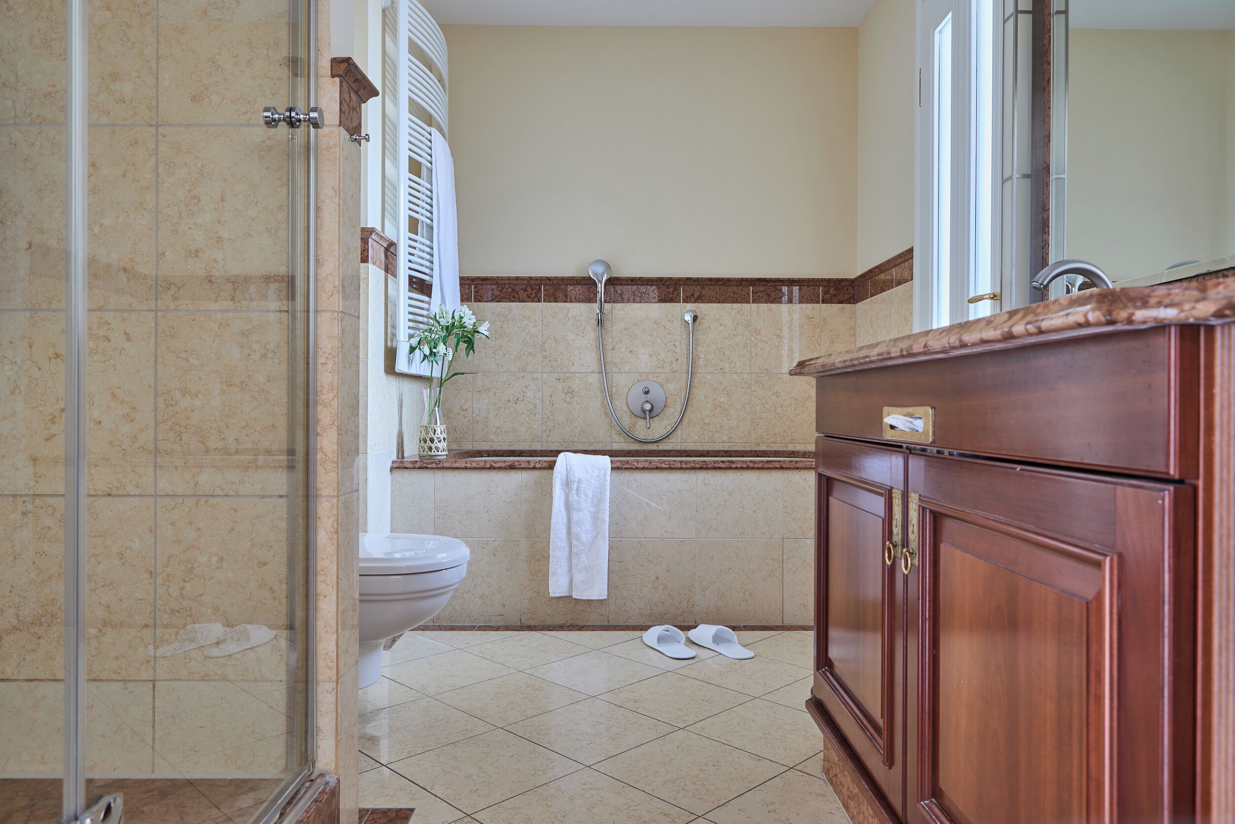 A bathroom with a shower, toilet, and vanity.