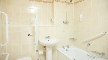 A bathroom with a toilet, sink, and bathtub.