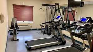 A gym with treadmills, a stationary bike, and a rowing machine. - Country Inn & Suites by Radisson, Midway - Tallahassee West (Midway)
