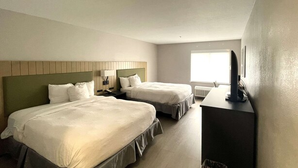 A hotel room with two beds, a desk, a chair, a TV, and a window. - Country Inn & Suites by Radisson, Midway - Tallahassee West (Midway)