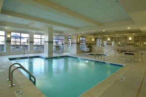 Relax by the pool, where a rectangular pool offers a refreshing escape with lounge chairs and tables nearby.