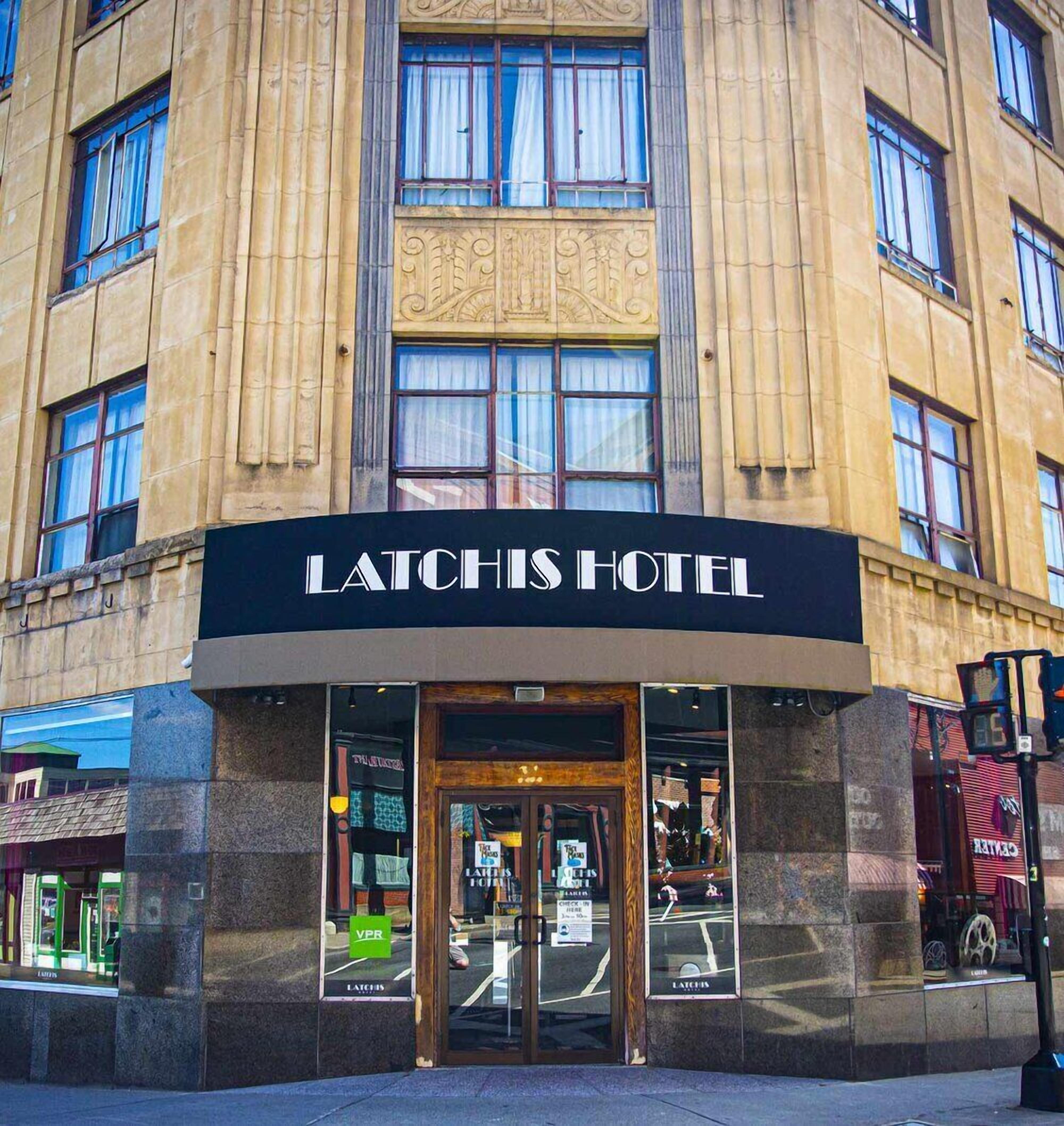 The exterior of Latchis Hotel with a classic architectural style, large windows, and a prominent entrance.