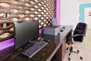 Work in comfort with a sleek desk, desktop computer, and printer.