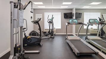 A fitness center with treadmills, elliptical machines, and weight machines.