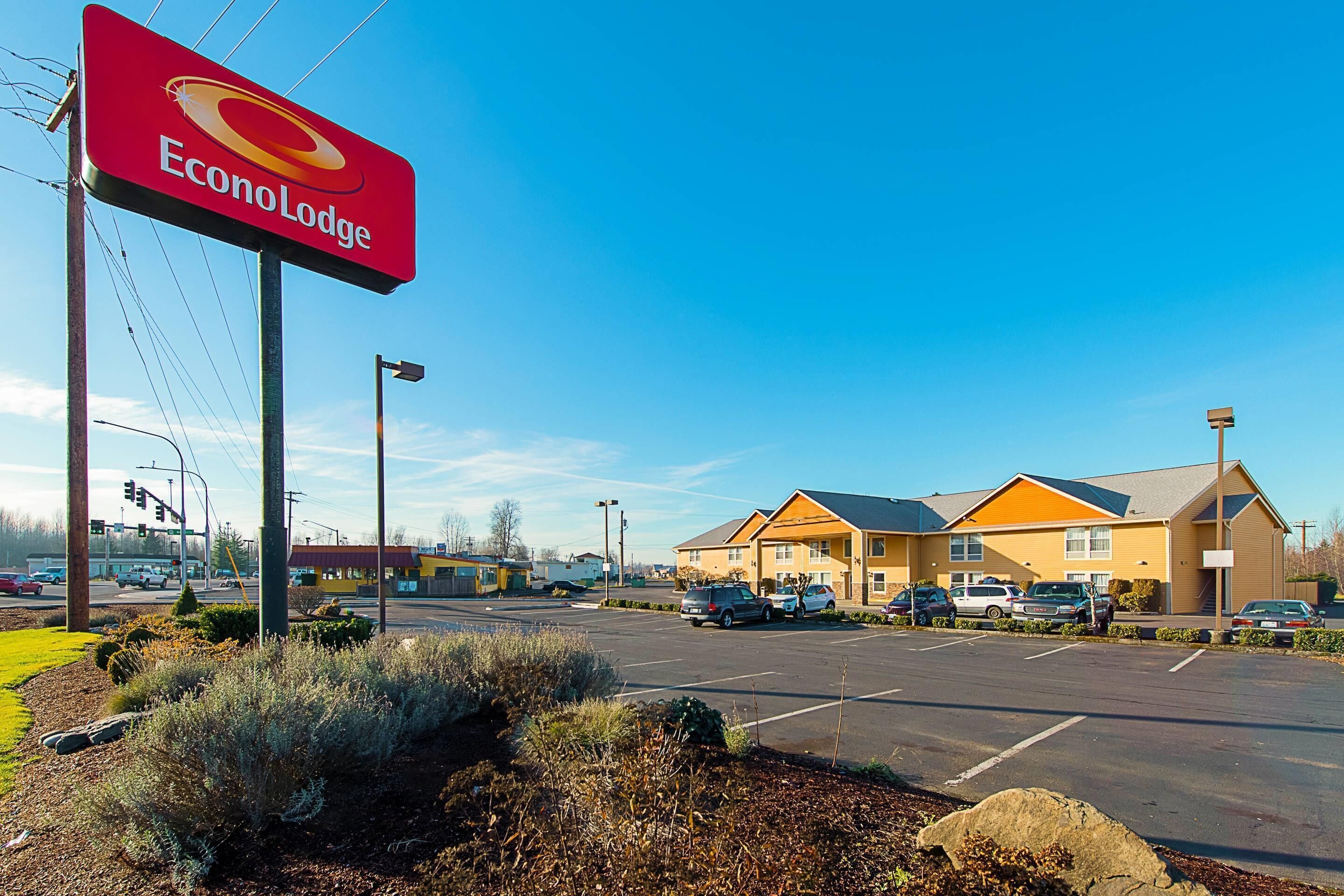 A parking lot with a building that has a sign reading 'Econo Lodge.'