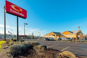 A parking lot with a building that has a sign reading 'Econo Lodge.'