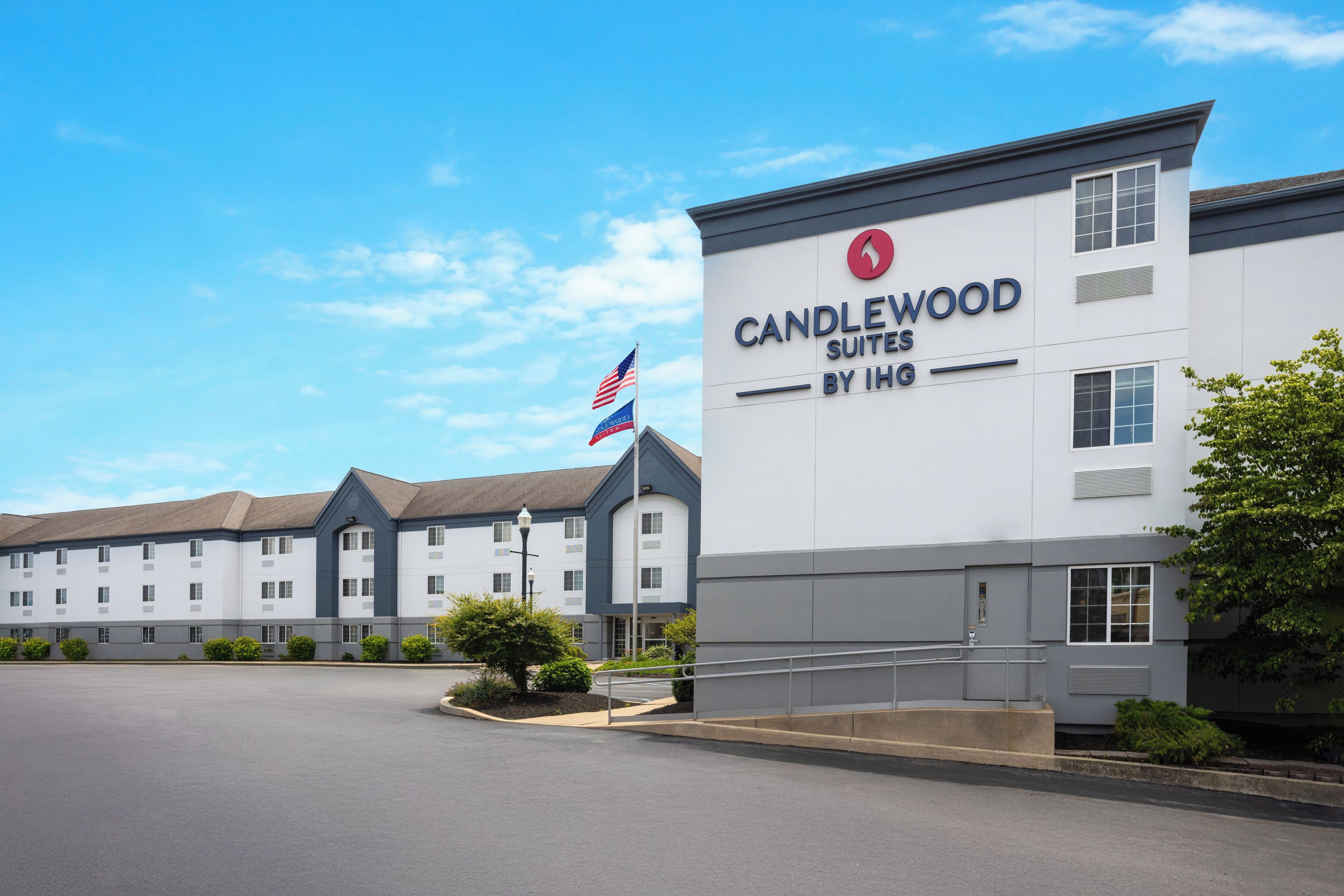 A hotel with a sign reading 'CANDLEWOOD SUITES BY IHG'.