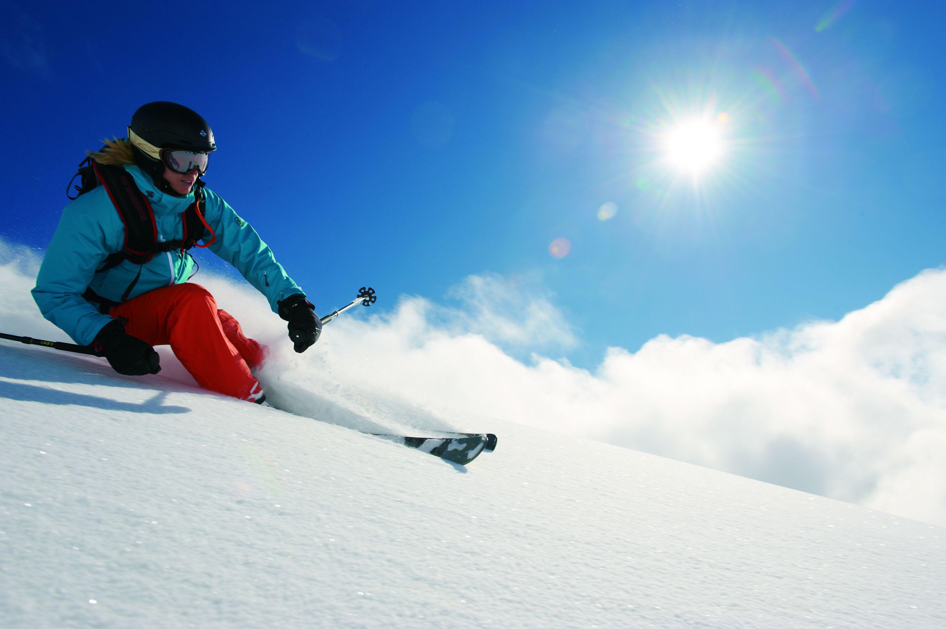 A person skiing down a snowy slope.