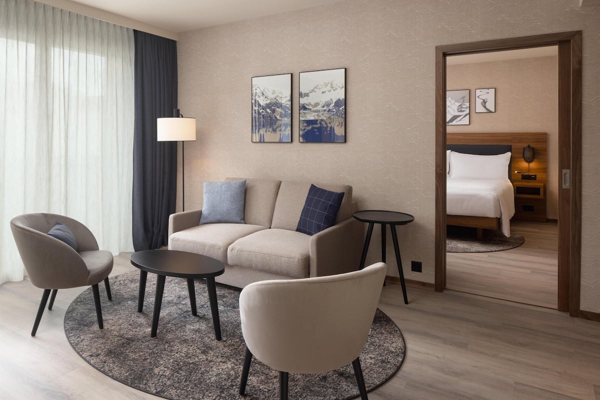 Junior Suite, 1 King Bed | Living area | 55-inch flat-screen TV with satellite channels, TV