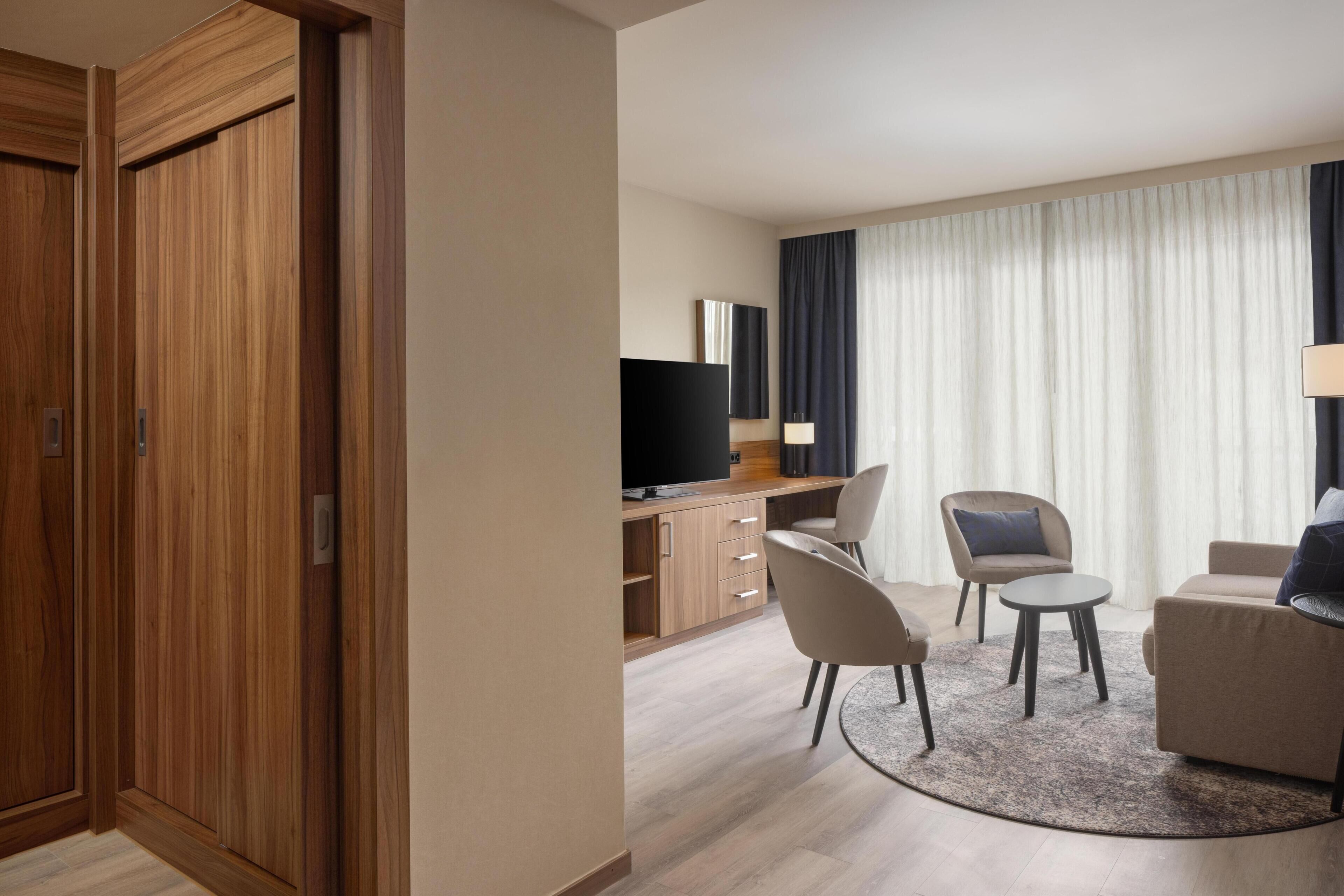 Junior Suite, 1 King Bed | Living area | 55-inch flat-screen TV with satellite channels, TV