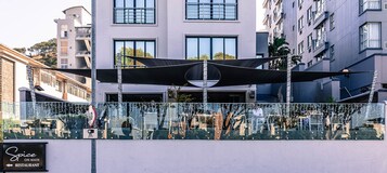 A modern building with a restaurant named "Spice" on the ground floor.