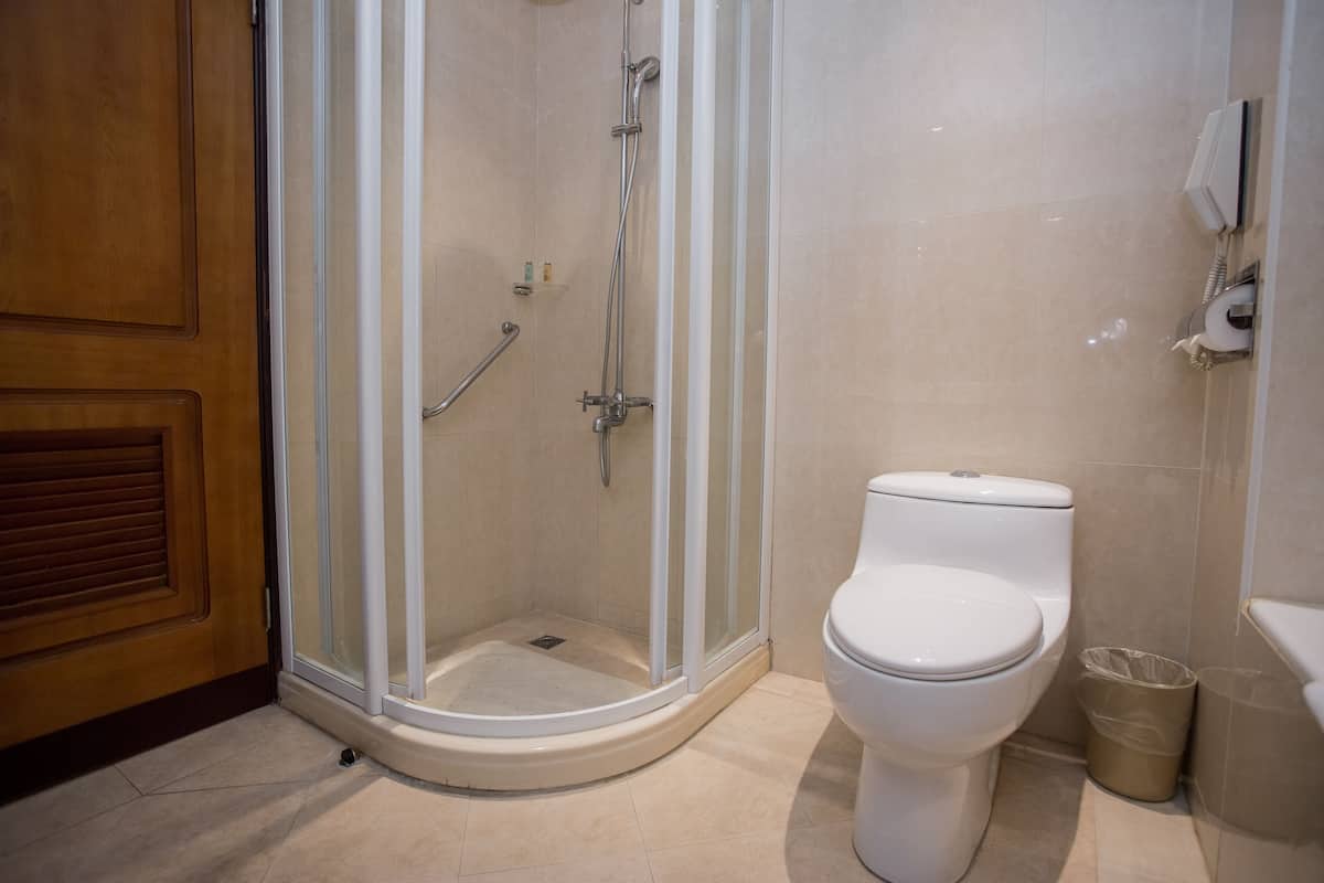 family suite | bathroom | deep-soaking bathtub, rainfall showerhead, hair dryer, slippers