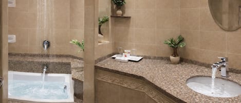 A bathroom with a bathtub, a sink, and a shower.