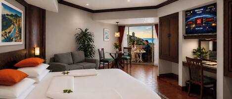 A hotel room with a bed, a dining area, a TV, and a view of the outside.