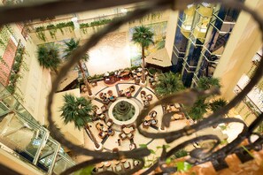 A spacious atrium with a central fountain, surrounded by seating areas and greenery. - Janfusun Resort Hotel (Gukeng)