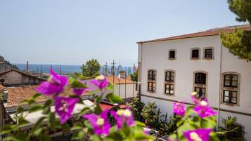 Situated near the sea, this charming building features a tiled roof and arched windows.