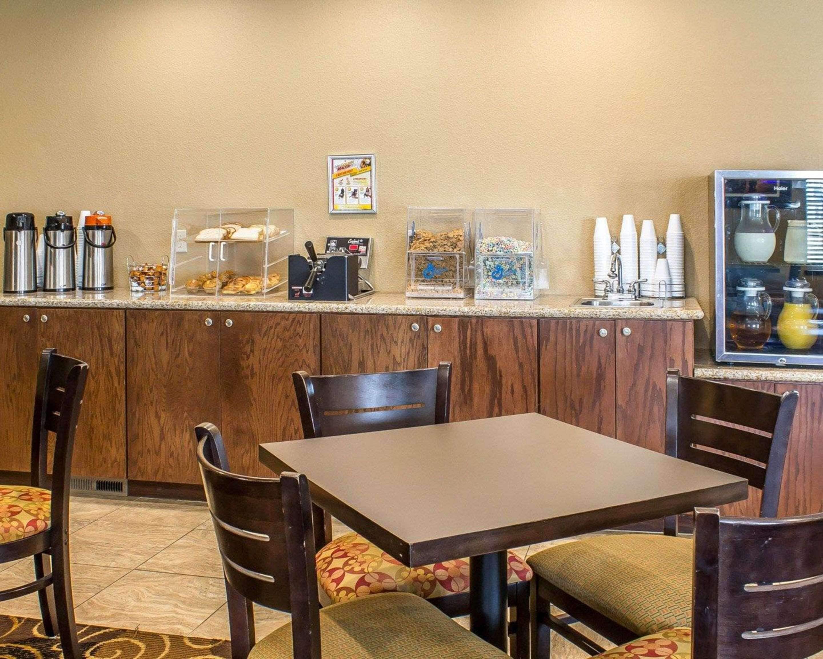 A hotel dining area with a buffet counter, chairs, and a table.