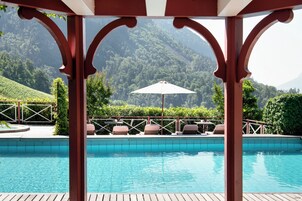 Una piscina al aire libre de temporada, sombrillas