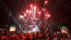 A crowded outdoor event with a stage and fireworks display. - Lifestyle Crown Residence Suites - All Inclusive (Puerto Plata)