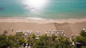 On the beach, sun loungers, beach umbrellas, beach towels