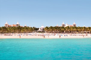 On the beach, white sand, sun-loungers, beach towels