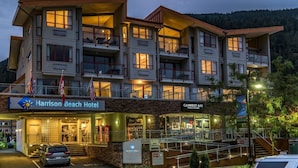A multi-story hotel with a stone facade, balconies, and a sign for 'Harrison Beach Hotel'. - Harrison Beach Hotel (Harrison Hot Springs)