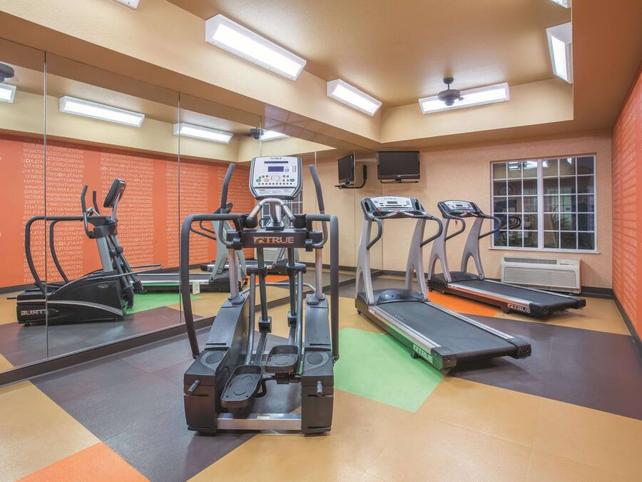 A gym with treadmills, a stationary bike, and a weight machine.