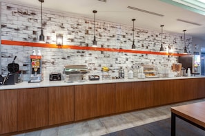 A breakfast bar with coffee machines, a radio, and a variety of food items. - Sleep Inn & Suites St Petersburg Gateway (St. Petersburg)