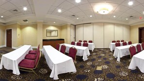 A conference room with tables and chairs, a large mirror, and a carpeted floor. - Holiday Inn Augusta West I-20 by IHG (Grovetown)