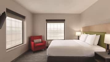 Una habitación de hotel con una cama, una silla roja, dos ventanas con persianas y una mesita de noche con lámpara.