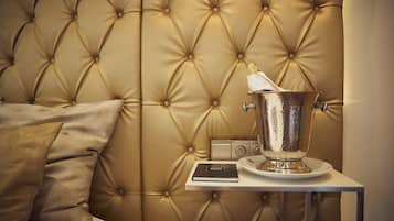 A tufted headboard, a bedside table with a book and a decorative container.