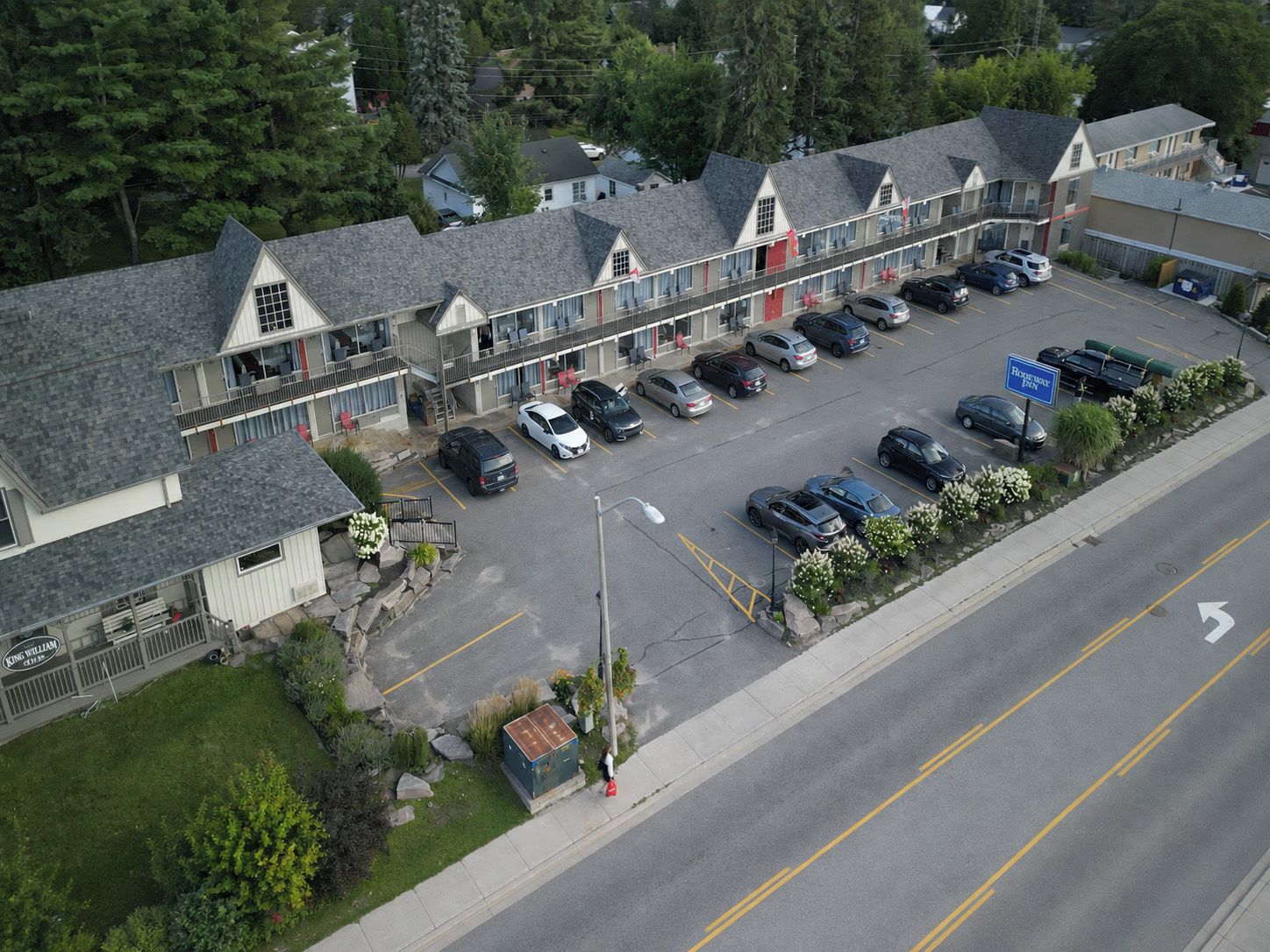 A motel with a parking lot and a road.