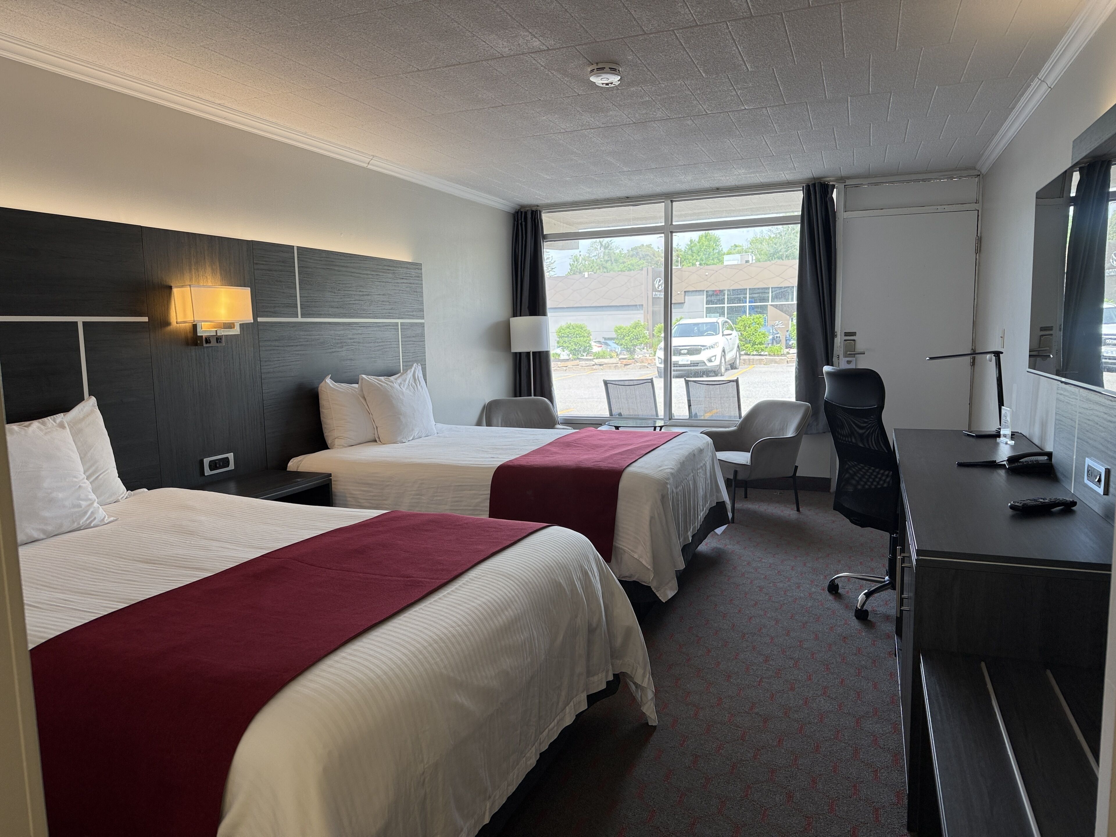 Room, 2 Queen Beds, Non Smoking | Living area | 32-inch TV with cable channels