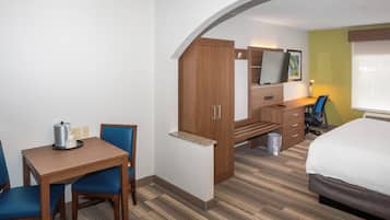 Suite, 1 King Bed | Desk, laptop workspace, blackout drapes, iron/ironing board