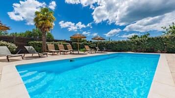 Seasonal outdoor pool, open 9:00 AM to 8:00 PM, pool umbrellas