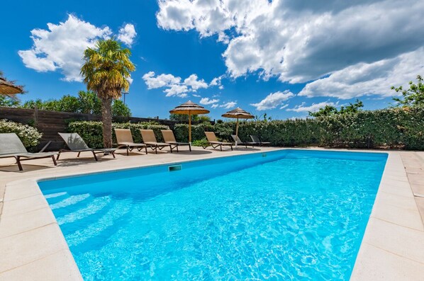 Seasonal outdoor pool, open 9:00 AM to 8:00 PM, pool umbrellas