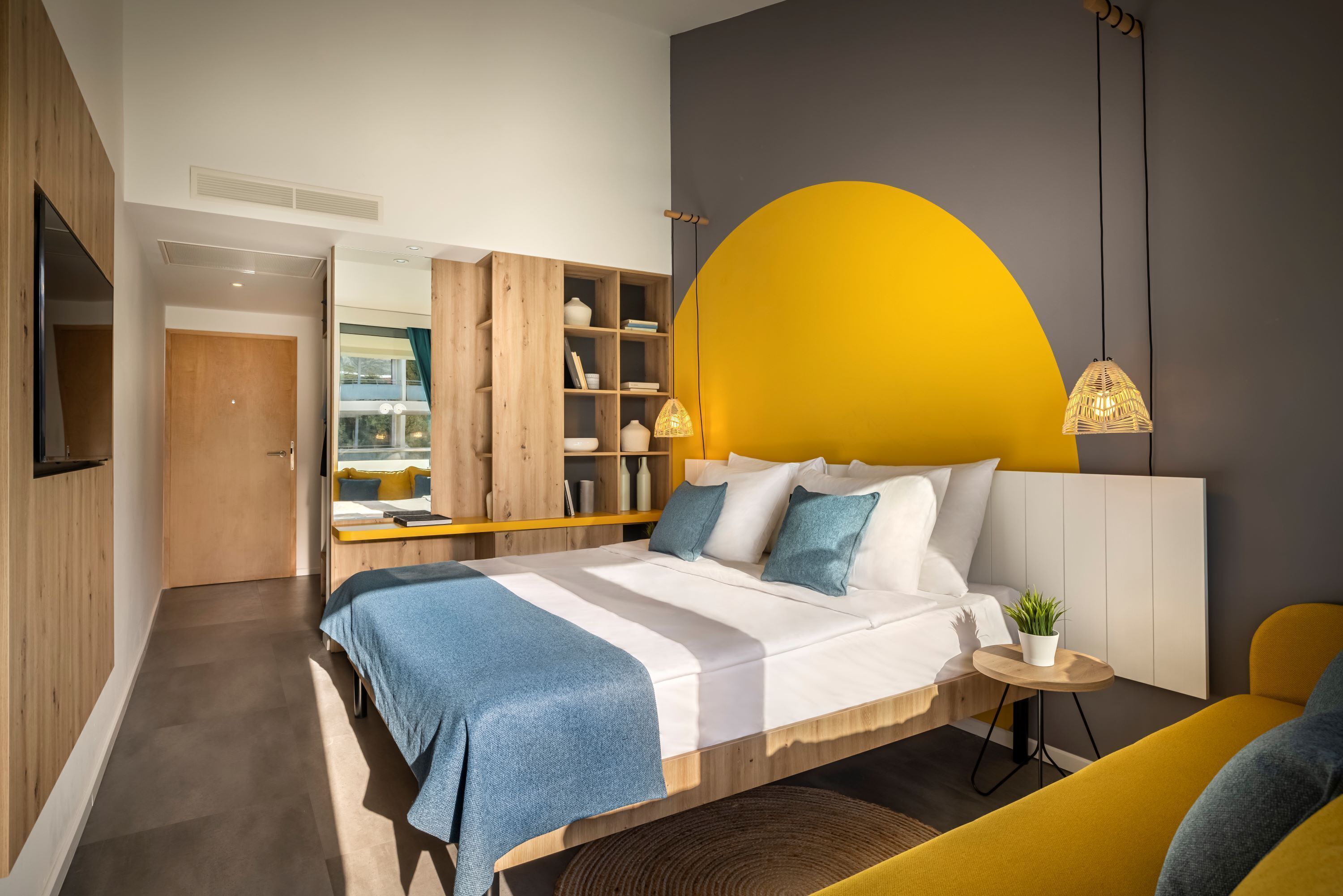 A modern bedroom with a bed, bedside table, and a built-in wardrobe.